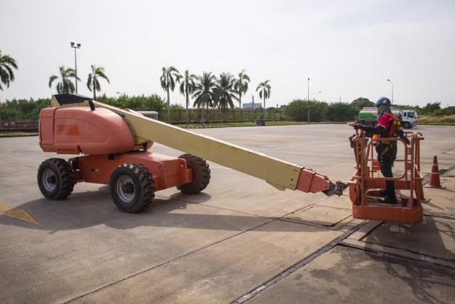 Male control boom lift in a industry working at high